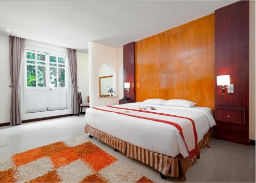 a large bedroom with a large bed and a large window at Petro House Hotel in Vung Tau