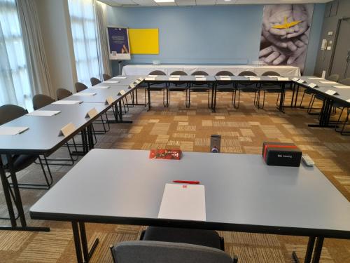 an empty classroom with white tables and chairs at ibis Nancy-Brabois in Vandoeuvre-lès-Nancy