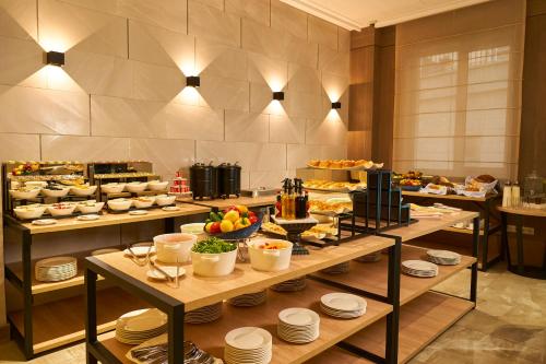 a buffet line with food on tables in a restaurant at City Stay Bishkek in Bishkek