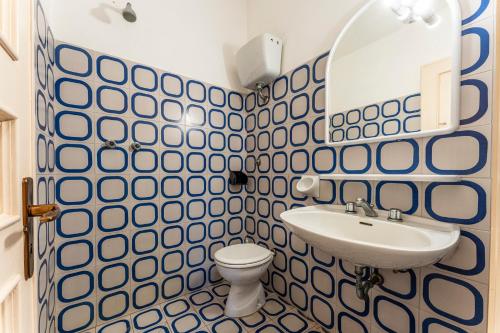 a bathroom with a sink and a toilet at Orbetello Giannella Apartment in Giannella
