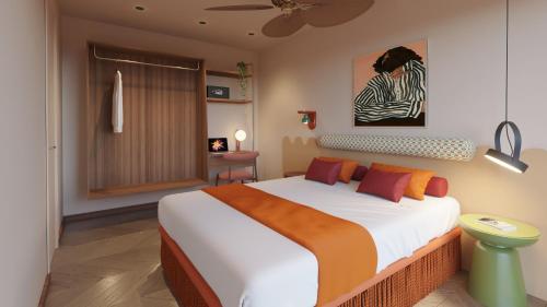 a bedroom with a large white bed with orange pillows at tent Mojito Suites in Magaluf