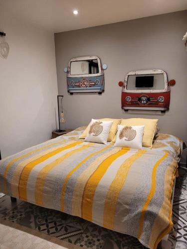 a bedroom with a bed with two vans on the wall at Charmant 2 pièces proche Plage in Fréjus