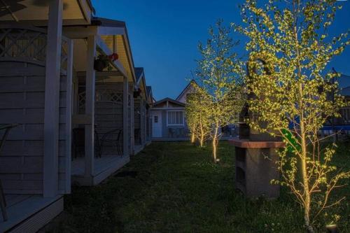 a row of houses with trees in the yard at New holiday homes for 2 people in Dziwn wek in Dziwnówek