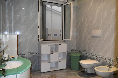 a bathroom with a sink and a toilet and a mirror at MONOPOLI MIA in Monopoli
