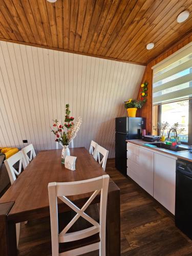 a kitchen with a wooden table with chairs and a sink at B&B Cottage in Mestia in Mestia