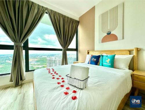 a bedroom with a bed with red rose petals on it at Macrolink Medini by RR JBcity in Nusajaya