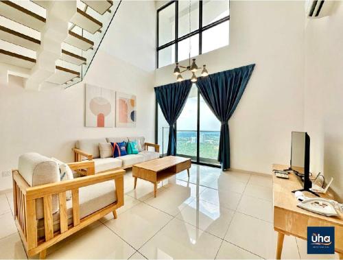 a living room with a couch and a tv at Macrolink Medini by RR JBcity in Nusajaya