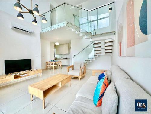 a living room with a couch and a tv at Macrolink Medini by RR JBcity in Nusajaya