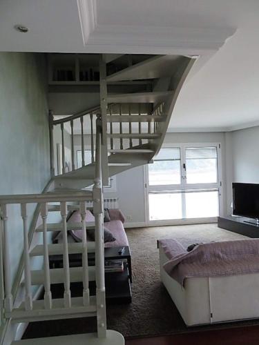 a bedroom with a bunk bed and a living room at EGONA-SLUI 1ªlínea playa, vista increible, garaje in Zarautz