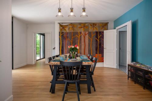 a dining room with a table and chairs at La Maison L'Eperon, stylish 5 star villa surrounded by vineyard near Saint Emilion in Vérac