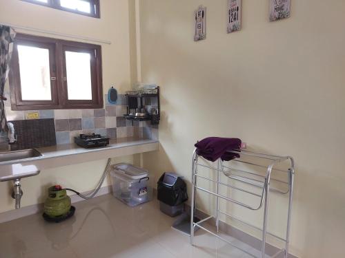 a kitchen with a sink and a towel on a rack at RiReRa Guest House Bogor Syariah in Kemangjampang