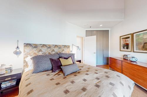 a bedroom with a large bed with purple pillows at Modern Park City Condo in Park City