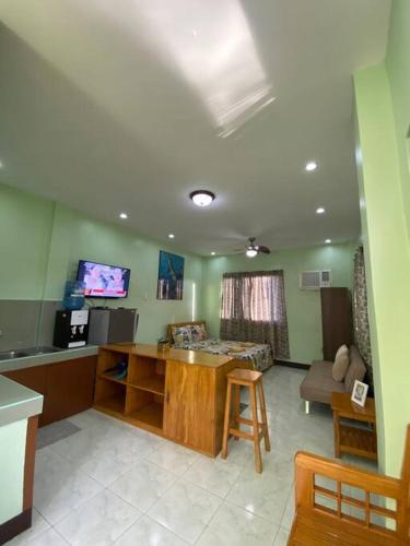 a living room with a table and a tv at Spacious Studio Apartment 3 with Pool in Alburquerque