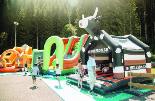 a group of people playing in an inflatable playground at La Pierre à Catillon in Moleson