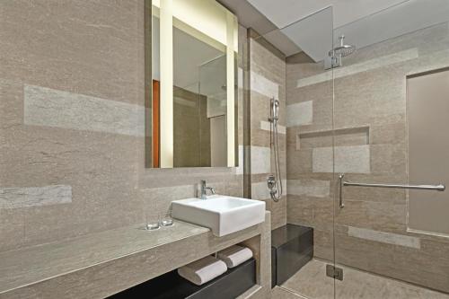 a bathroom with a sink and a mirror at Courtyard by Marriott Bali Nusa Dua Resort in Nusa Dua