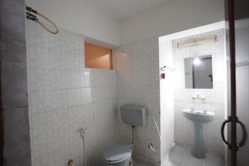 a bathroom with a toilet and a sink at Luciya International Mysore in Mysore