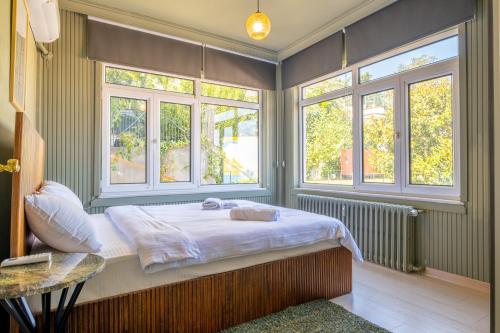 a bedroom with a bed in a room with windows at Stunning 2Br Apt at the Brim of the Bosphorus in Istanbul