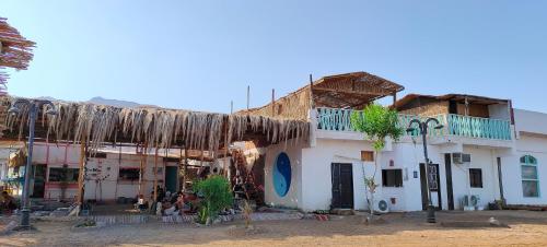 a group of buildings withamboo at Michael's House in Nuweiba