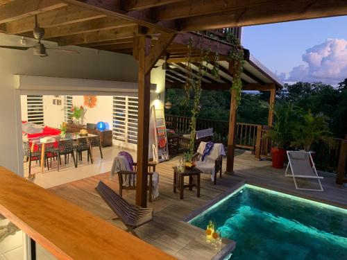 a patio with a swimming pool and a table and chairs at VILLA CAZARAMEL in Le Gosier