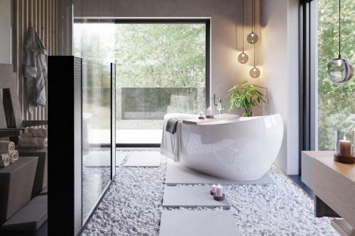 a bathroom with a white tub and a sink at Avidea - Adults Only in Lagundo