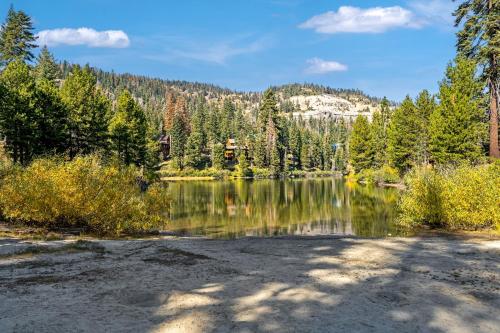a lake with trees and a mountain in the background at Centrally Located and Dog Friendly! - Home #36 in Bear Valley