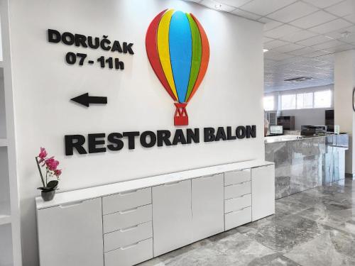 a sign for a restaurant with a hot air balloon at Hotel Balon in Velika Kladuša