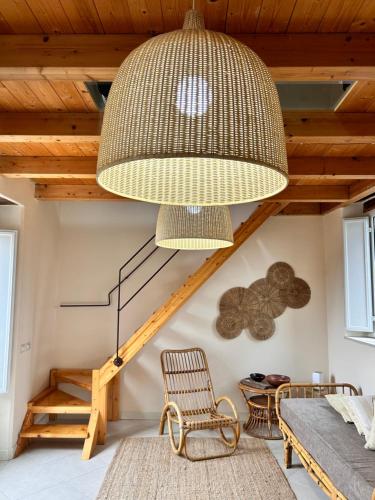 a room with a chair and a chandelier at Massaria Bove in Cervino