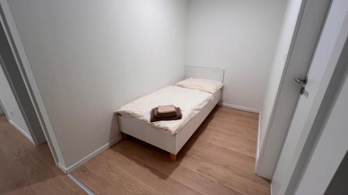 a small white room with a small bed in it at 2 room Apartment with terrace, new building, 2BK in Bratislava