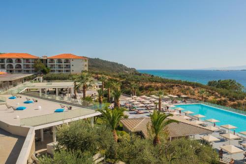 an aerial view of a resort with a pool and the ocean at Akrathos Beach Hotel in Ouranoupoli