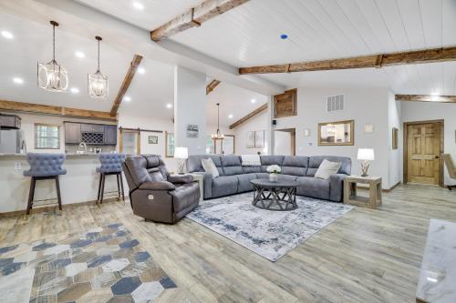 a living room with a couch and a table at Whiskey Pines Retreat! Single Level Home, Outdoor Firepit, AC, BBQ! Sleeps 9 in Lake Harmony! in Lake Harmony