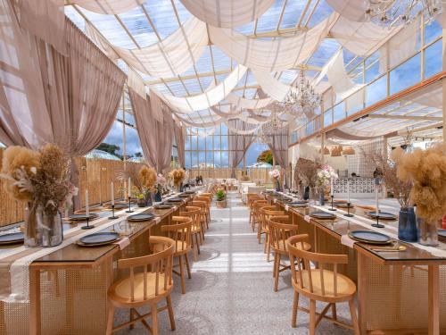 a dining room with long tables and chairs at Stellar GoldenHill Cameron in Tanah Rata