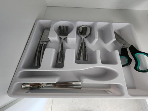 a white tray with silver utensils in it at Wagenaar Villas in Monte Vista