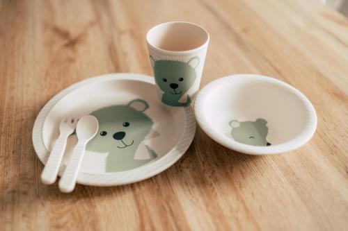 two dishes with stuffed animals on them on a table at Luga Homes - Karli in Leipzig