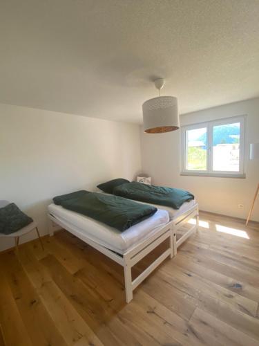 a bedroom with a bed in a room with a window at Chalet Bergdohle in Rosswald