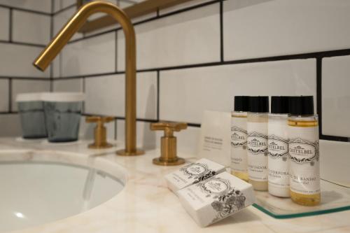 a bathroom counter with a sink and toiletries on it at Dona Maria Hotel in Figueira da Foz