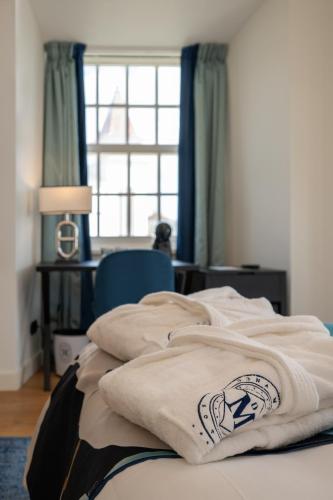 a bed in a room with a window at Dona Maria Hotel in Figueira da Foz