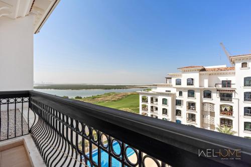 a balcony of a building with a view of the ocean at WelHome - Luxury Apt Close to Yas Water and Ferrari World in Abu Dhabi
