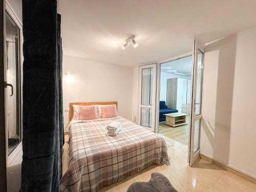 a bedroom with a bed and a glass door at Renthouse Apartments City Gates #5 in Chişinău