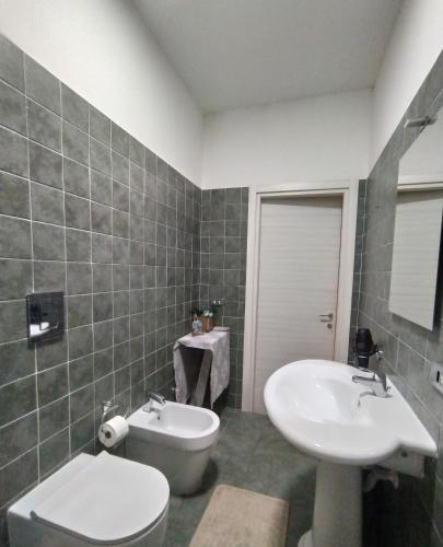 a bathroom with a toilet and a sink at Appartamento Fotia in Giugliano in Campania