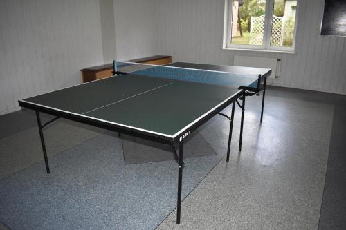 a ping pong table in a room with at Ośrodek Wypoczynkowy Ania Dźwirzyno in Dźwirzyno