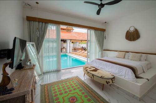 a bedroom with a bed and a swimming pool at Keramas Moonlight Villa in Keramas