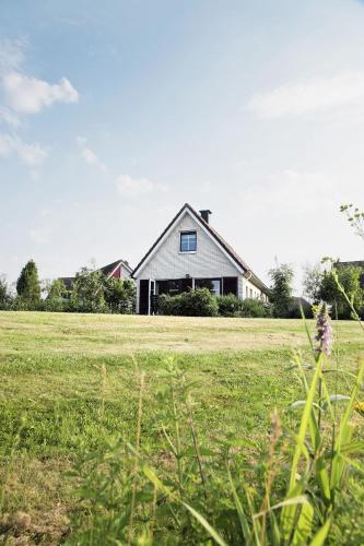 a house in the middle of a field at Center Parcs Sandur Emmen in Emmen