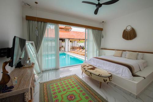 a bedroom with a bed and a swimming pool at Keramas Moonlight Villa in Keramas