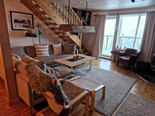 a living room with a couch and a table at Åre-Bjørnen Falken 17A in Åre