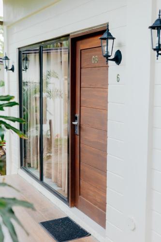 a wooden door on a house with a porch at Spacio Caliraya Bed & Breakfast in Lumban