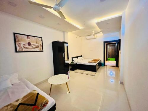 a room with two beds and a table in it at A.P. Suite - Luxury Villa in Ujjain