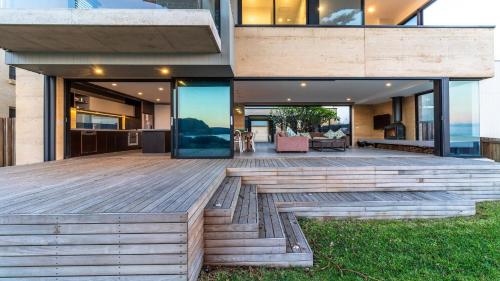 a wooden deck in front of a house at Ocean Beach Pavilion - Beachfront in Umina