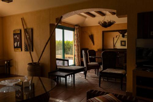 a living room with chairs and a table and a window at Ras Sedr Royal Beach Villa at Sinaway Lagoon Hotel & Spa- Ras Sedr, Egypt in Ras Sedr