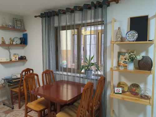a dining room with a table and a window at Central Home Away From Home in Shkodër