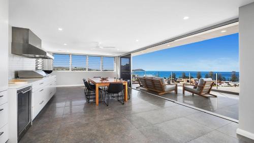 una cucina e una sala da pranzo con vista sull'oceano di Amazing Views and Short Walk To Beach a Terrigal